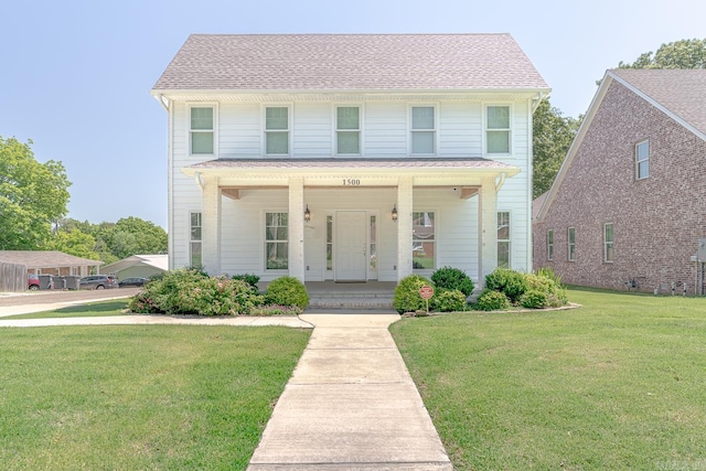 1500 S Church St, Jonesboro, AR 72401 - view of front of property featuring covered porch, a front lawn, and roof with shingles