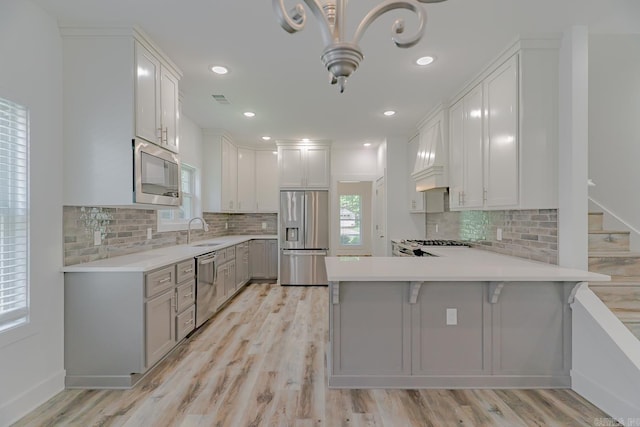 1500 S Church St, Jonesboro, AR 72401 - kitchen with appliances with stainless steel finishes, a peninsula, light countertops, tasteful backsplash, and recessed lighting