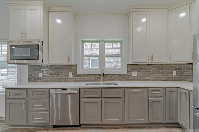 1500 S Church St, Jonesboro, AR 72401 - kitchen with dishwasher, built in microwave, a sink, and gray cabinets