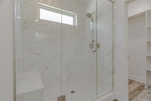 1500 S Church St, Jonesboro, AR 72401 - bathroom featuring a stall shower, a walk in closet, and wood finished floors