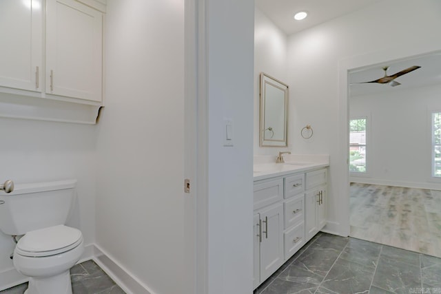 1500 S Church St, Jonesboro, AR 72401 - bathroom featuring vanity, toilet, baseboards, marble finish flooring, and recessed lighting