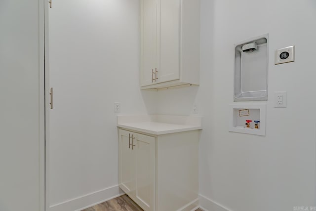 1500 S Church St, Jonesboro, AR 72401 - laundry room featuring hookup for an electric dryer, hookup for a washing machine, cabinet space, baseboards, and light wood-type flooring