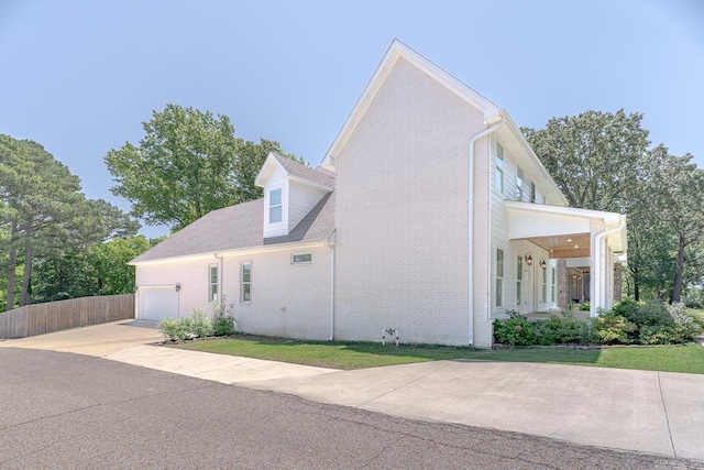 1500 S Church St, Jonesboro, AR 72401 - view of home's exterior with an attached garage, brick siding, and concrete driveway