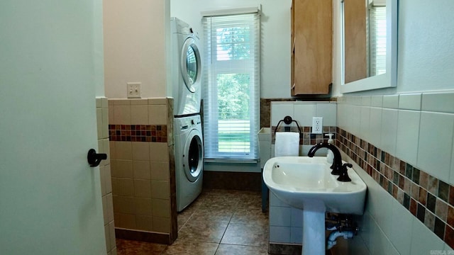 157 E Hawkview Pl, Royal, AR 71968 - laundry area featuring stacked washer / dryer, tile walls, dark tile patterned floors, and a wainscoted wall