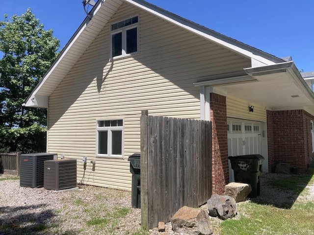157 E Hawkview Pl, Royal, AR 71968 - view of side of property with central air condition unit, brick siding, and a garage