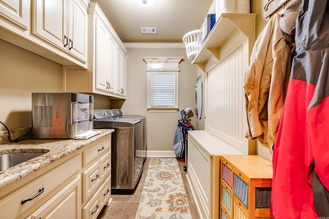 3891 Harrison Rd, Benton, AR 72019 - laundry room with independent washer and dryer, ornamental molding, baseboards, light tile patterned floors, and cabinet space