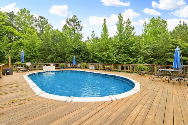 3891 Harrison Rd, Benton, AR 72019 - view of swimming pool with outdoor dining space and a wooden deck