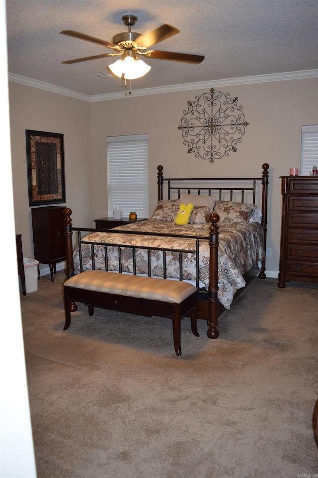carpeted bedroom featuring crown molding, a textured ceiling, and a ceiling fan