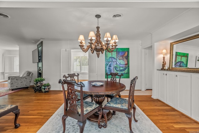 5412 S Grandview St, Little Rock, AR 72207 - dining room featuring ornamental molding, a chandelier, light wood-type flooring, and baseboards