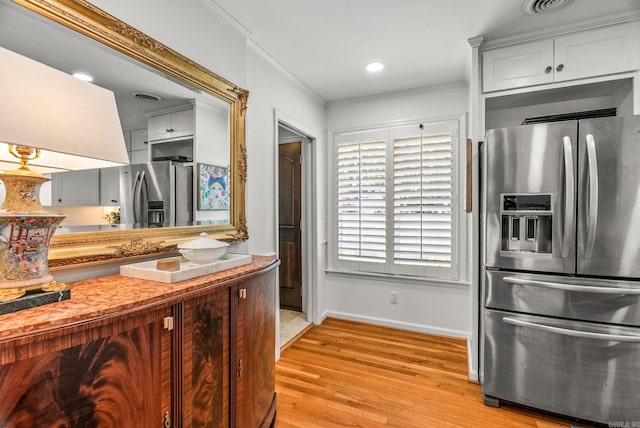 5412 S Grandview St, Little Rock, AR 72207 - kitchen featuring stainless steel fridge with ice dispenser, baseboards, ornamental molding, light wood-type flooring, and light countertops