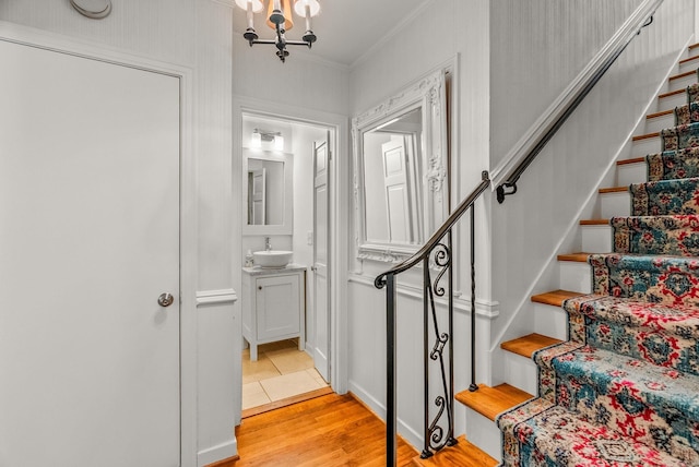 5412 S Grandview St, Little Rock, AR 72207 - stairway with wood finished floors, a chandelier, and crown molding