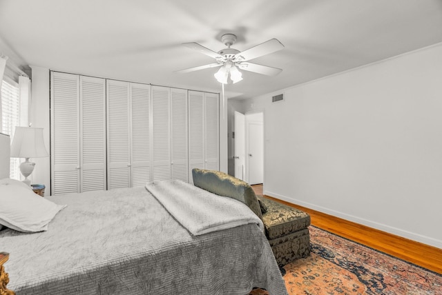 5412 S Grandview St, Little Rock, AR 72207 - bedroom with wood finished floors, baseboards, two closets, and ceiling fan