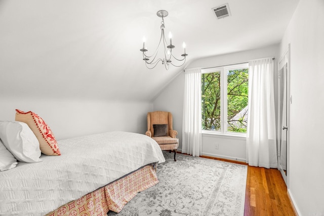 5412 S Grandview St, Little Rock, AR 72207 - bedroom with wood finished floors, a chandelier, vaulted ceiling, and baseboards