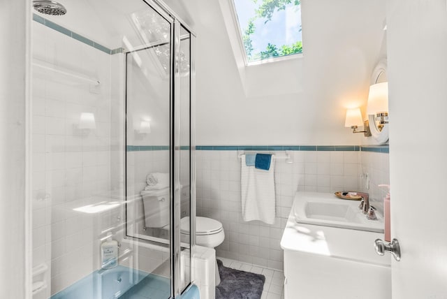 5412 S Grandview St, Little Rock, AR 72207 - full bath with toilet, vanity, tile walls, a skylight, and tile patterned floors