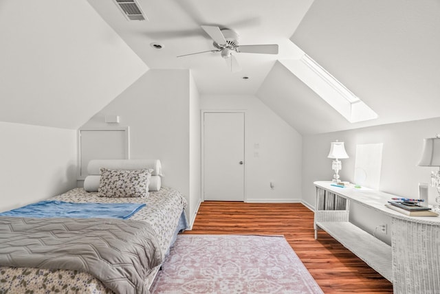 5412 S Grandview St, Little Rock, AR 72207 - bedroom with wood finished floors, vaulted ceiling, a skylight, and a ceiling fan