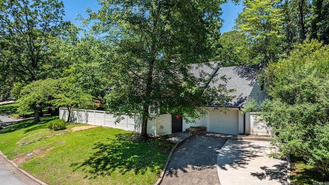 5412 S Grandview St, Little Rock, AR 72207 - obstructed view of property with asphalt driveway, a front yard, a shingled roof, and a garage