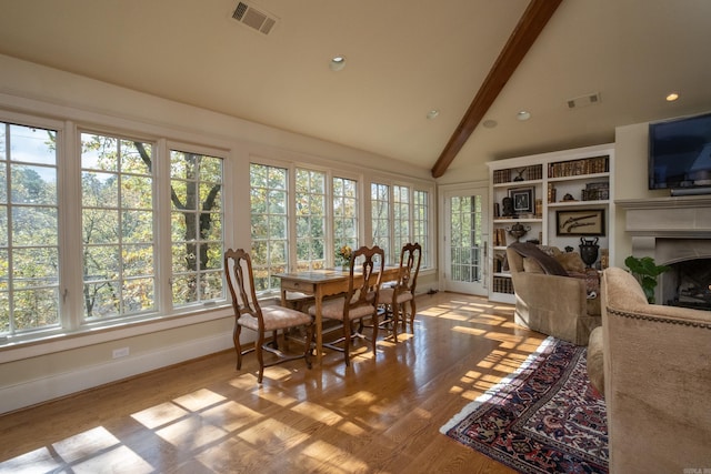 5313 N Grandview St, Little Rock, AR 72207 - sunroom with baseboards, beam ceiling, wood finished floors, and high vaulted ceiling