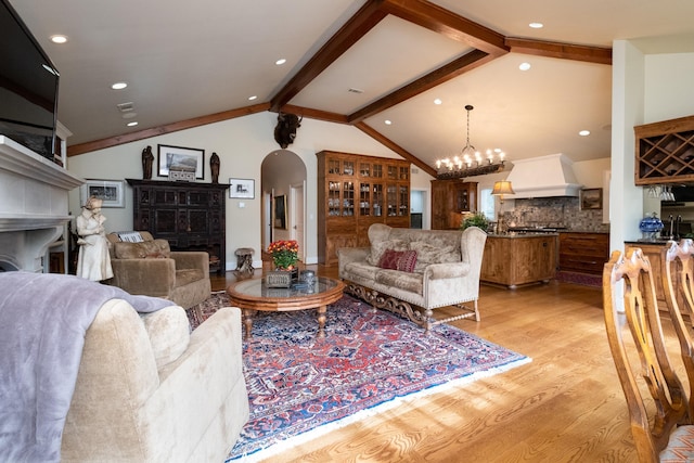 5313 N Grandview St, Little Rock, AR 72207 - living area featuring a fireplace, light wood-style flooring, arched walkways, recessed lighting, and a chandelier