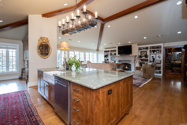 5313 N Grandview St, Little Rock, AR 72207 - kitchen featuring stainless steel dishwasher, a sink, a warm lit fireplace, light stone counters, and recessed lighting