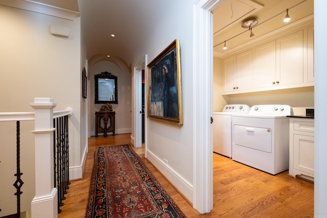5313 N Grandview St, Little Rock, AR 72207 - corridor featuring separate washer and dryer, light wood-type flooring, and attic access