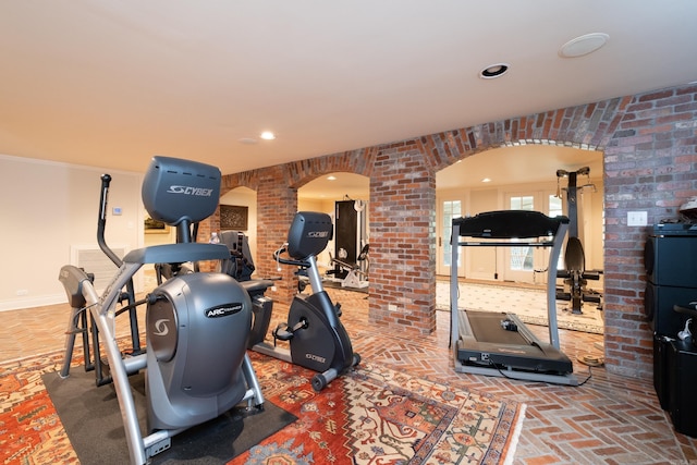5313 N Grandview St, Little Rock, AR 72207 - workout room featuring arched walkways, recessed lighting, baseboards, and brick flooring