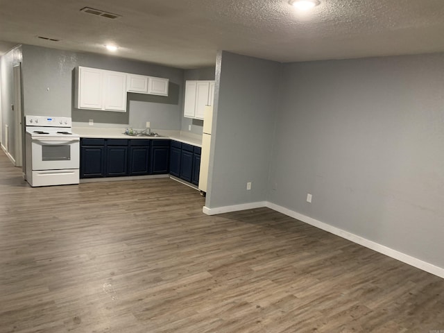 442 S Thornton, Piggott, AR 72454 - kitchen featuring white range with electric cooktop, baseboards, wood finished floors, a sink, and a textured ceiling
