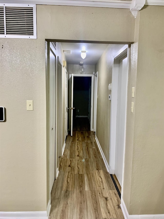 5405 Dreher Ln, Little Rock, AR 72209 - corridor with light wood-style flooring, baseboards, and a textured wall