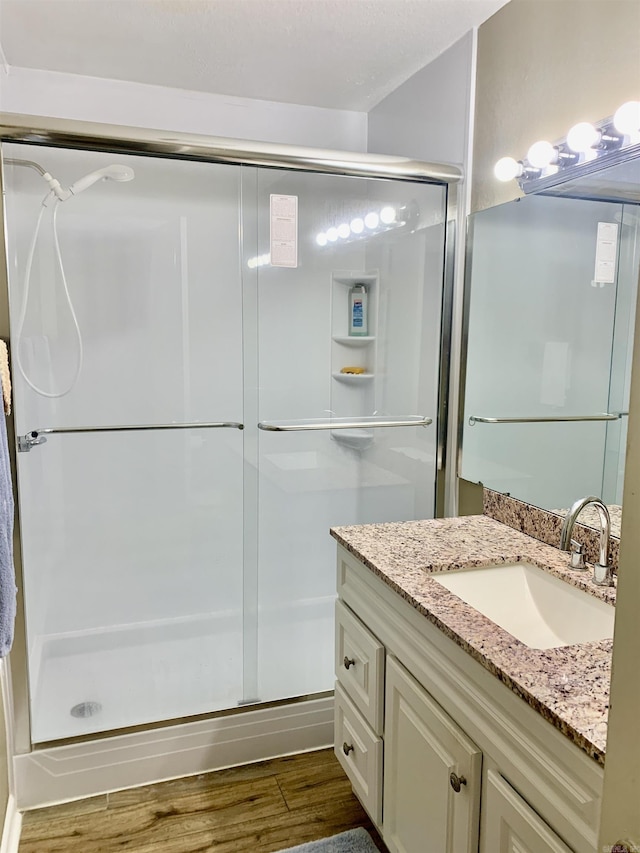 5405 Dreher Ln, Little Rock, AR 72209 - bathroom featuring a shower stall, vanity, and wood finished floors