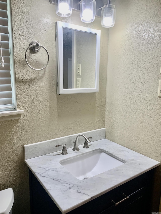 5405 Dreher Ln, Little Rock, AR 72209 - bathroom featuring vanity, toilet, and a textured wall