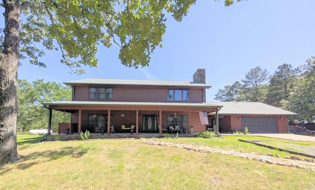 149 Polk Rd Unit 714, Mena, AR 71953 - view of front facade featuring a chimney, a front lawn, a garage, and driveway