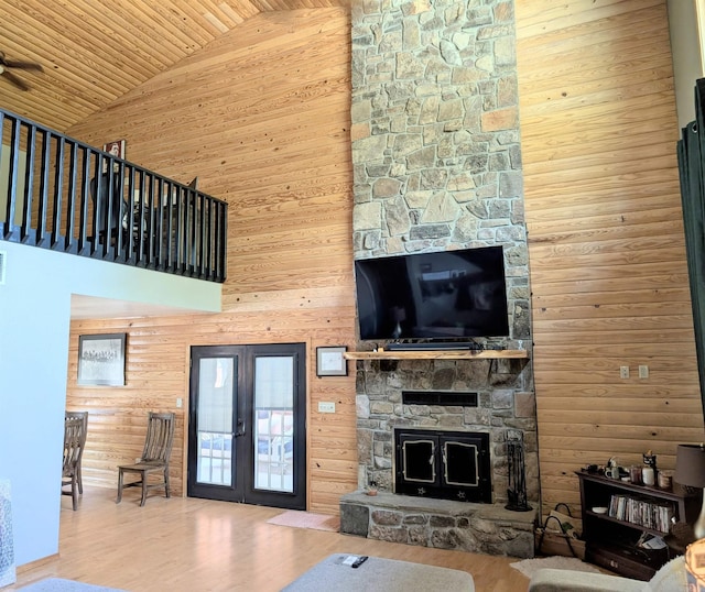 149 Polk Rd Unit 714, Mena, AR 71953 - living area featuring high vaulted ceiling, a stone fireplace, wood finished floors, french doors, and wooden ceiling