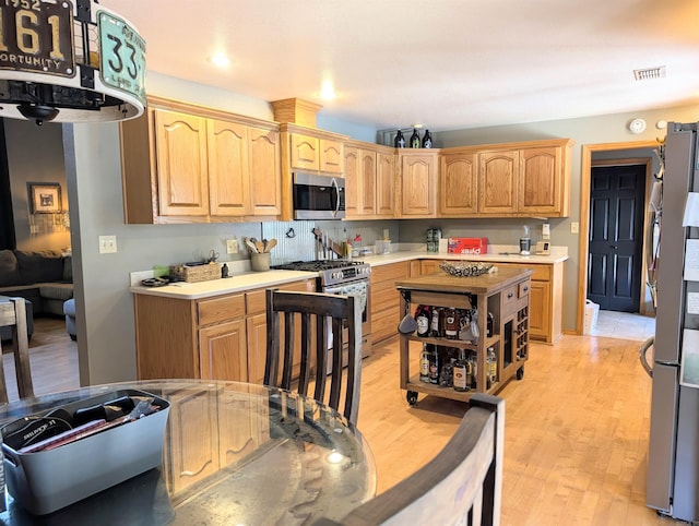 149 Polk Rd Unit 714, Mena, AR 71953 - kitchen with appliances with stainless steel finishes, light countertops, light wood-type flooring, and light brown cabinetry