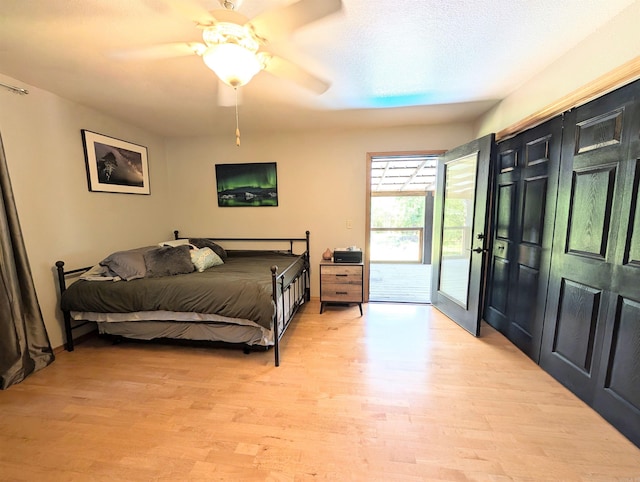 149 Polk Rd Unit 714, Mena, AR 71953 - bedroom featuring access to exterior, light wood-style floors, and ceiling fan
