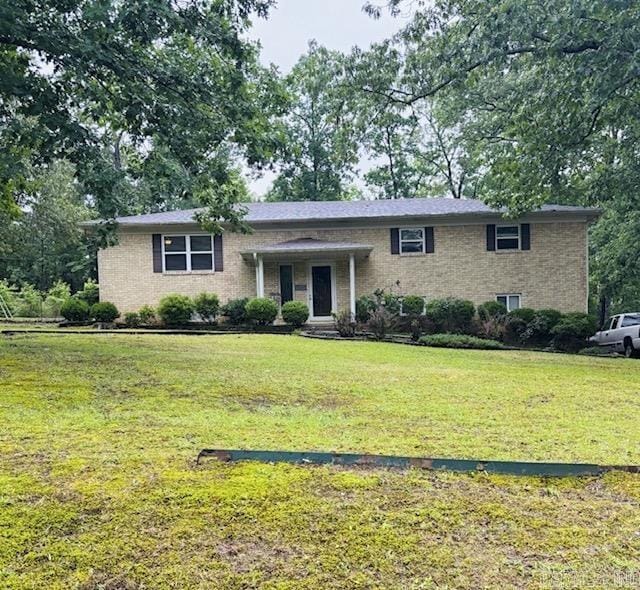 7219 Pinewood, Mabelvale, AR 72103 - view of front of home featuring a front lawn and brick siding