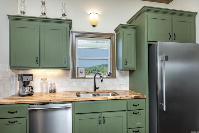 410 Rocky Point Rd, Vilonia, AR 72173 - kitchen with stainless steel appliances, green cabinets, a sink, butcher block counters, and decorative backsplash