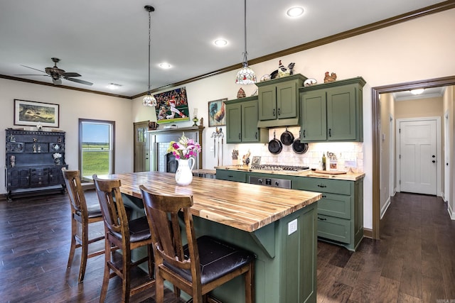 410 Rocky Point Rd, Vilonia, AR 72173 - kitchen with green cabinets, butcher block counters, ornamental molding, backsplash, and a kitchen bar