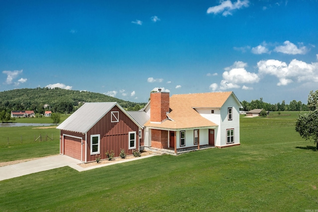 410 Rocky Point Rd, Vilonia, AR 72173 - view of front of home with board and batten siding, a chimney, a garage, and a front yard