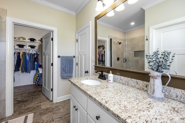 410 Rocky Point Rd, Vilonia, AR 72173 - full bath with vanity, a walk in closet, a stall shower, crown molding, and baseboards