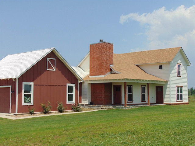 410 Rocky Point Rd, Vilonia, AR 72173 - view of front of house with a chimney, a front yard, board and batten siding, a porch, and an attached garage