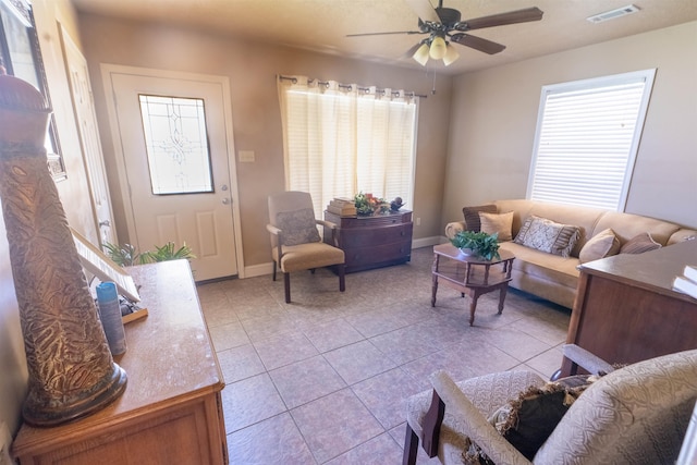 815 Meadowbrook Ln S, Wynne, AR 72396 - living area with light tile patterned floors, healthy amount of natural light, a ceiling fan, and baseboards