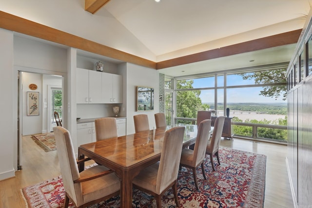 8 River View Pt, Little Rock, AR 72227 - dining area featuring lofted ceiling, light wood-style flooring, and a water view