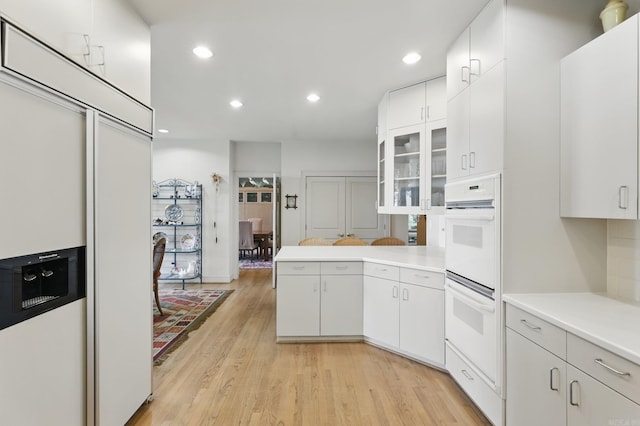 8 River View Pt, Little Rock, AR 72227 - kitchen featuring light countertops, white double oven, light wood-type flooring, white cabinetry, and recessed lighting