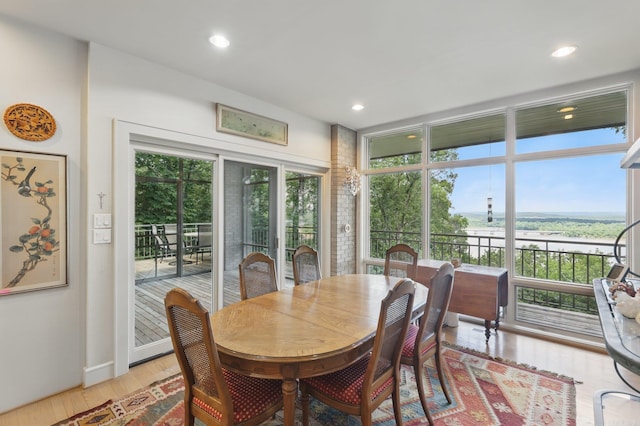 8 River View Pt, Little Rock, AR 72227 - dining space with light wood-type flooring, a water view, recessed lighting, and baseboards