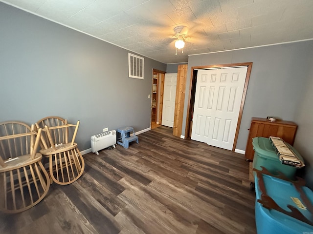 221 N Garfield Ave, Piggott, AR 72454 - sitting room featuring a ceiling fan, wood finished floors, and baseboards