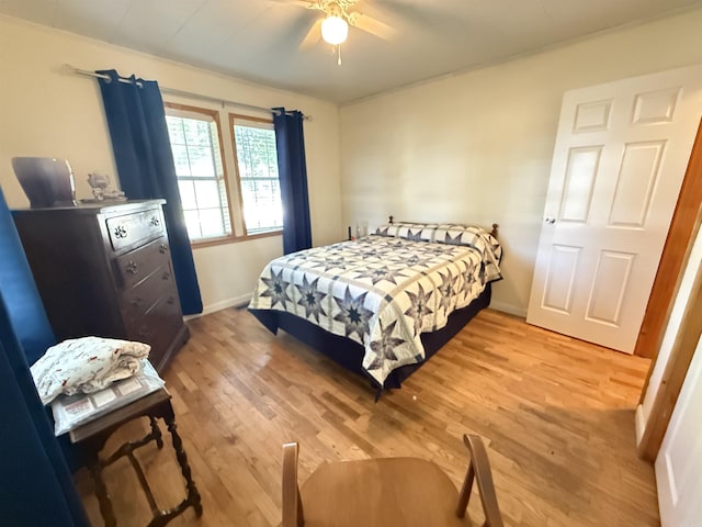 221 N Garfield Ave, Piggott, AR 72454 - bedroom featuring light wood finished floors, baseboards, and ceiling fan