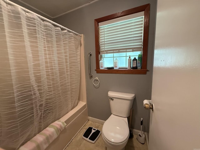 221 N Garfield Ave, Piggott, AR 72454 - bathroom featuring toilet, shower / bath combo with shower curtain, baseboards, and tile patterned flooring