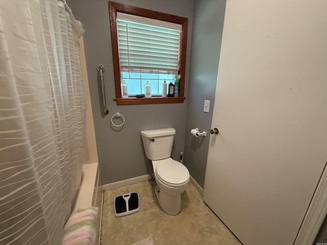 221 N Garfield Ave, Piggott, AR 72454 - full bath featuring toilet, tile patterned flooring, shower / tub combo, and baseboards