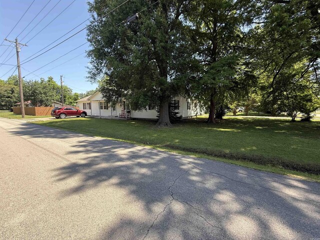 221 N Garfield Ave, Piggott, AR 72454 - view of property hidden behind natural elements featuring a front lawn