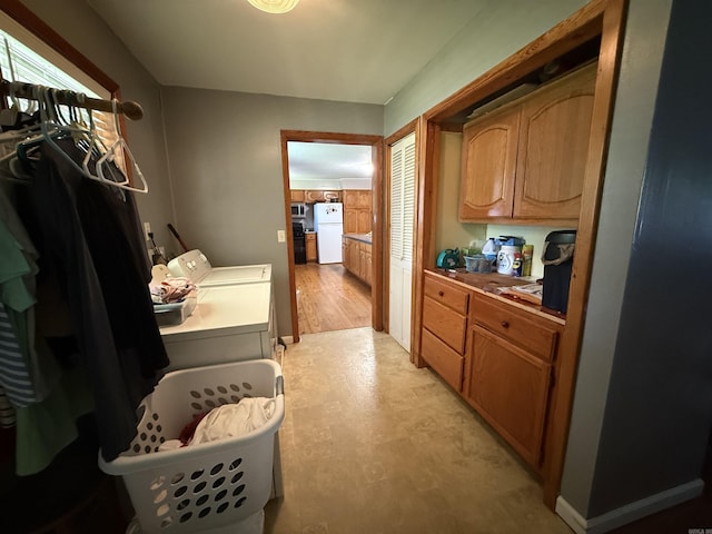 221 N Garfield Ave, Piggott, AR 72454 - laundry room featuring washing machine and clothes dryer, cabinet space, and light floors