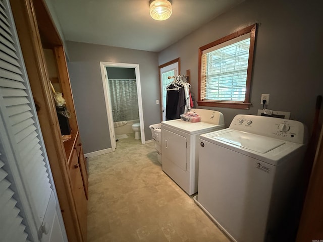 221 N Garfield Ave, Piggott, AR 72454 - laundry room with separate washer and dryer and baseboards
